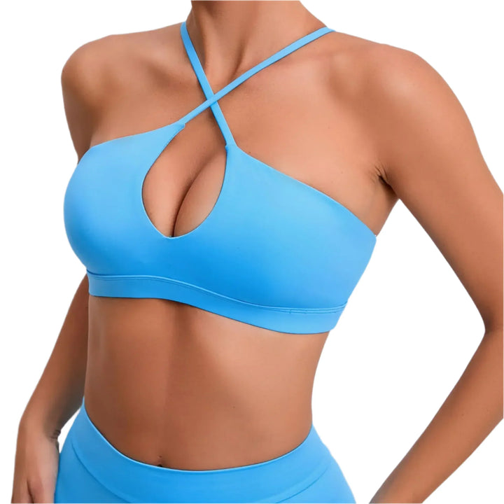 Blue sports bra and shorts on a plain background